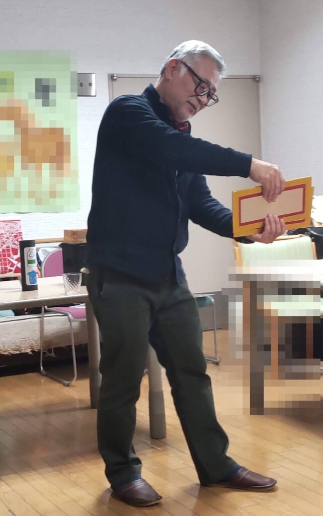 大阪吹田市の老人施設でのボランティア・マジックショー。平べったいパネルからコップを出すマジックです。